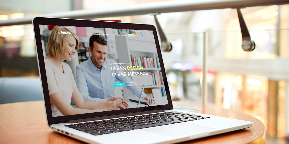 Laptop displaying a couple browsing a catalog in a cozy setting.