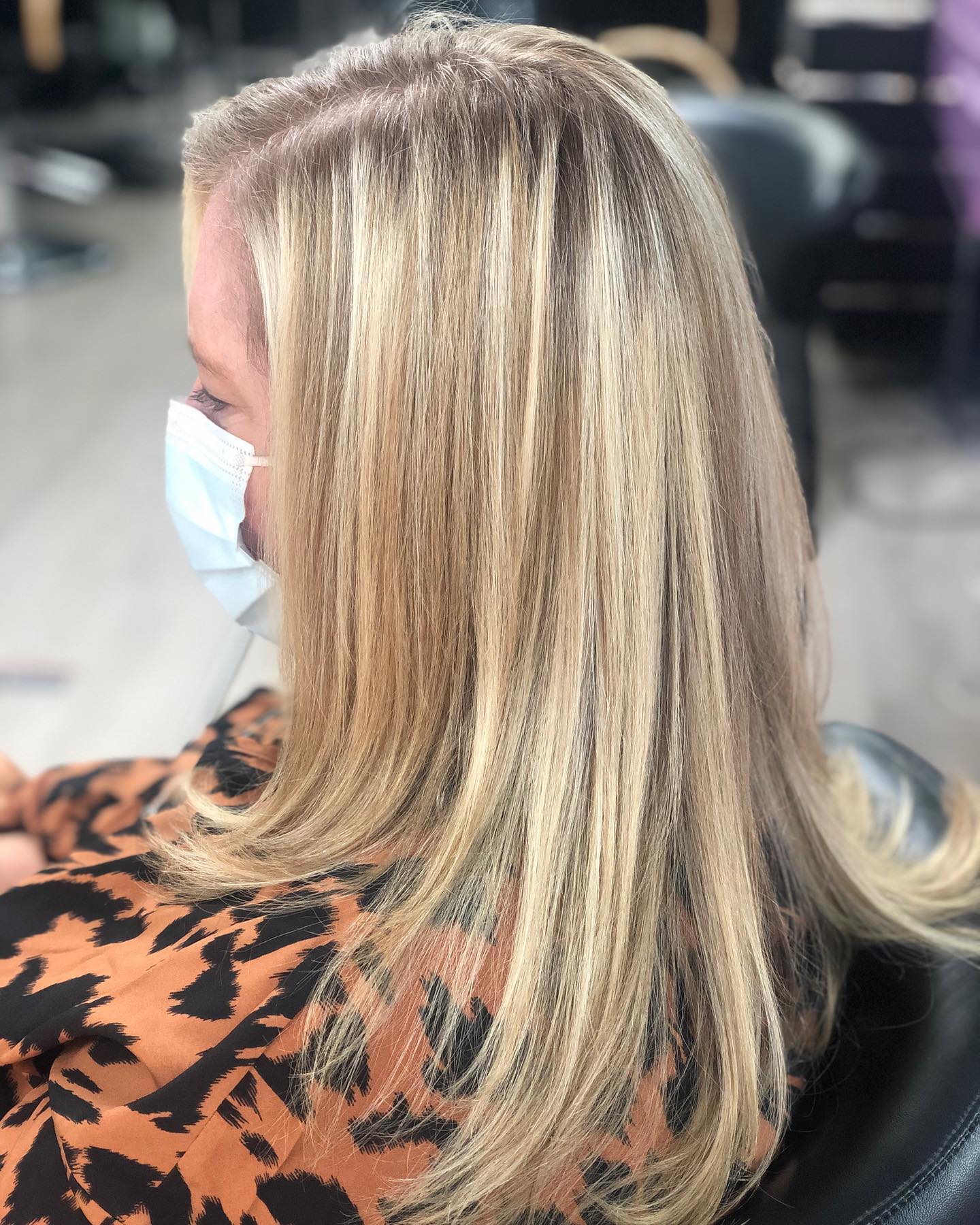 Shoulder-length blonde hair with layered ends, viewed from the side.