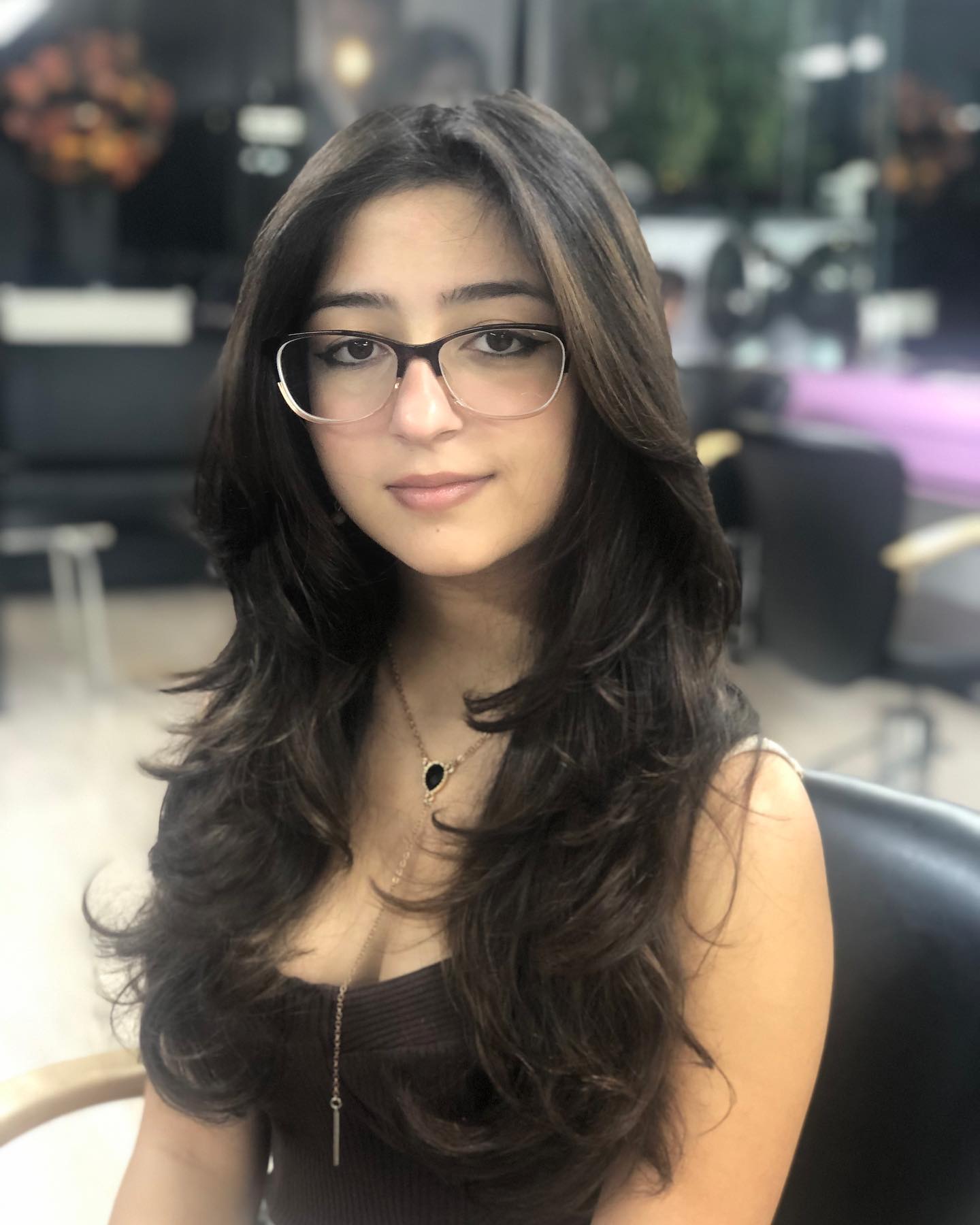 Long dark layered hair with softly turned ends.
