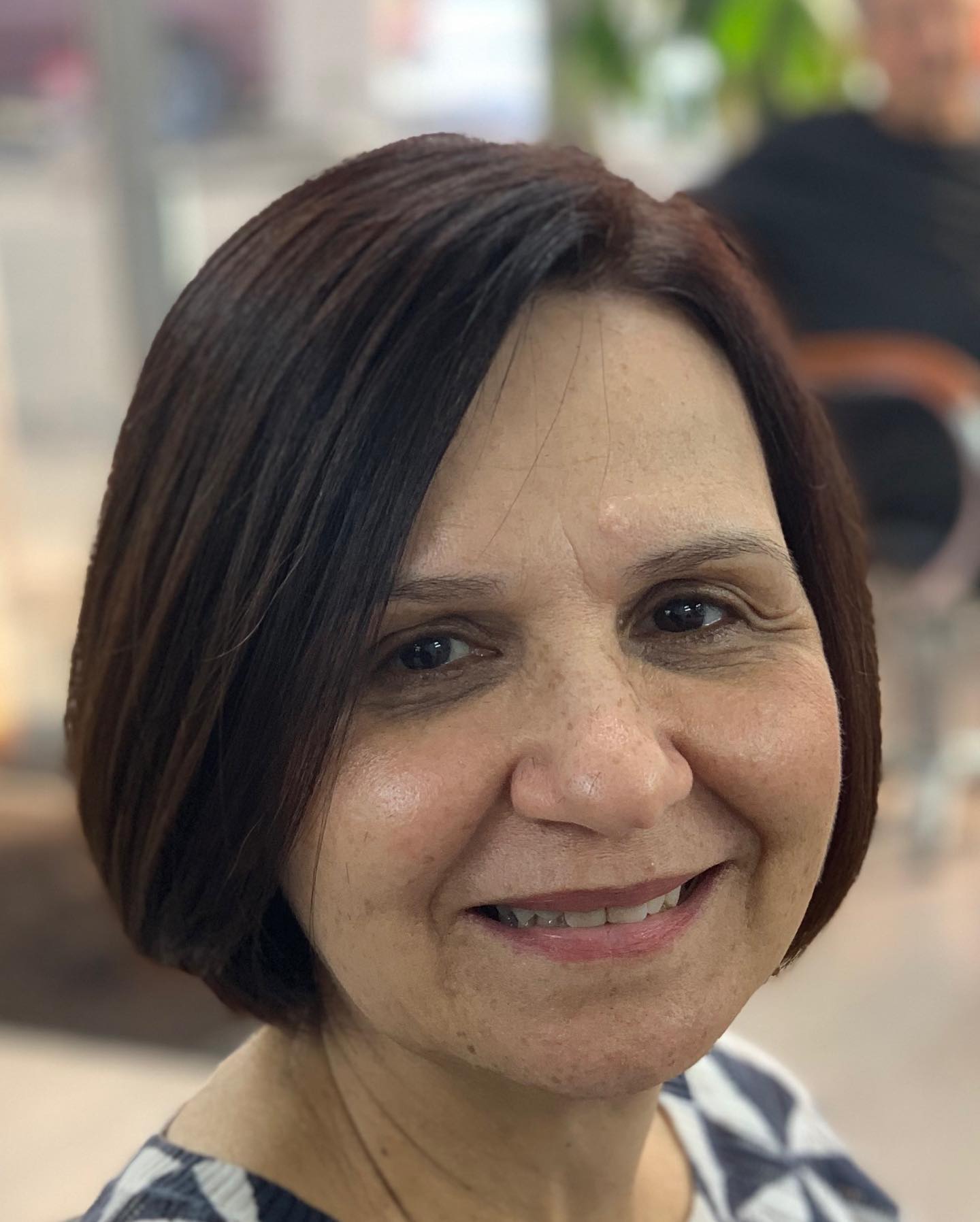 Chin-length dark bob with a side part.