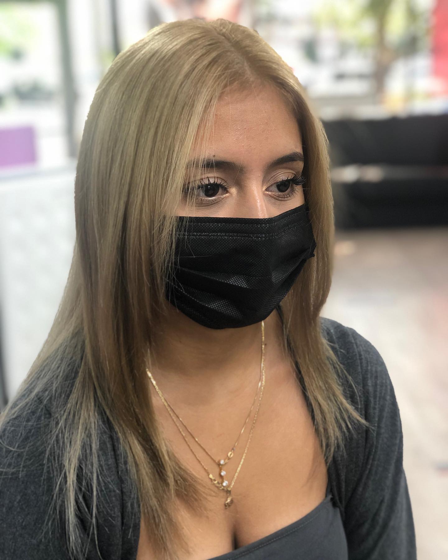 Straight blonde hair falling below the shoulders.